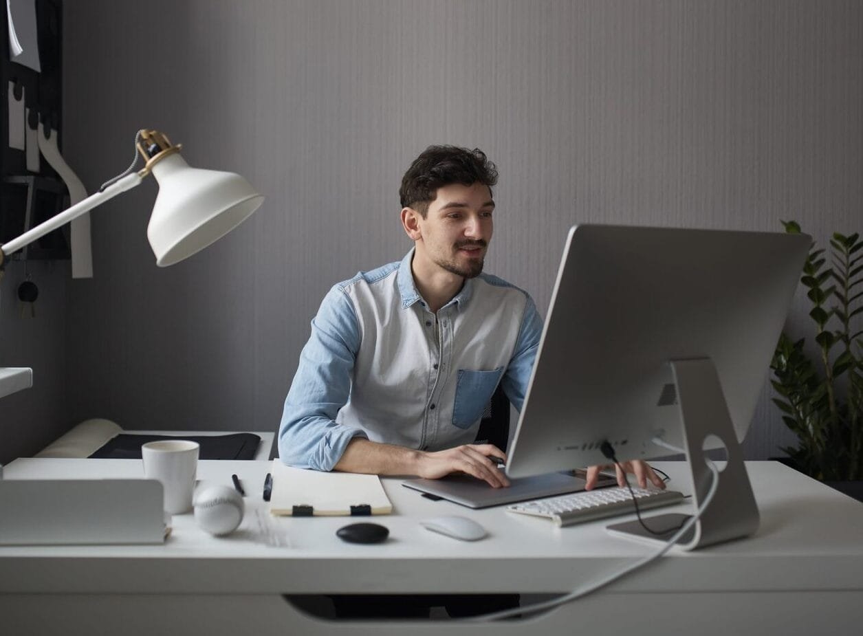 Young male designer using graphics tablet while working with com